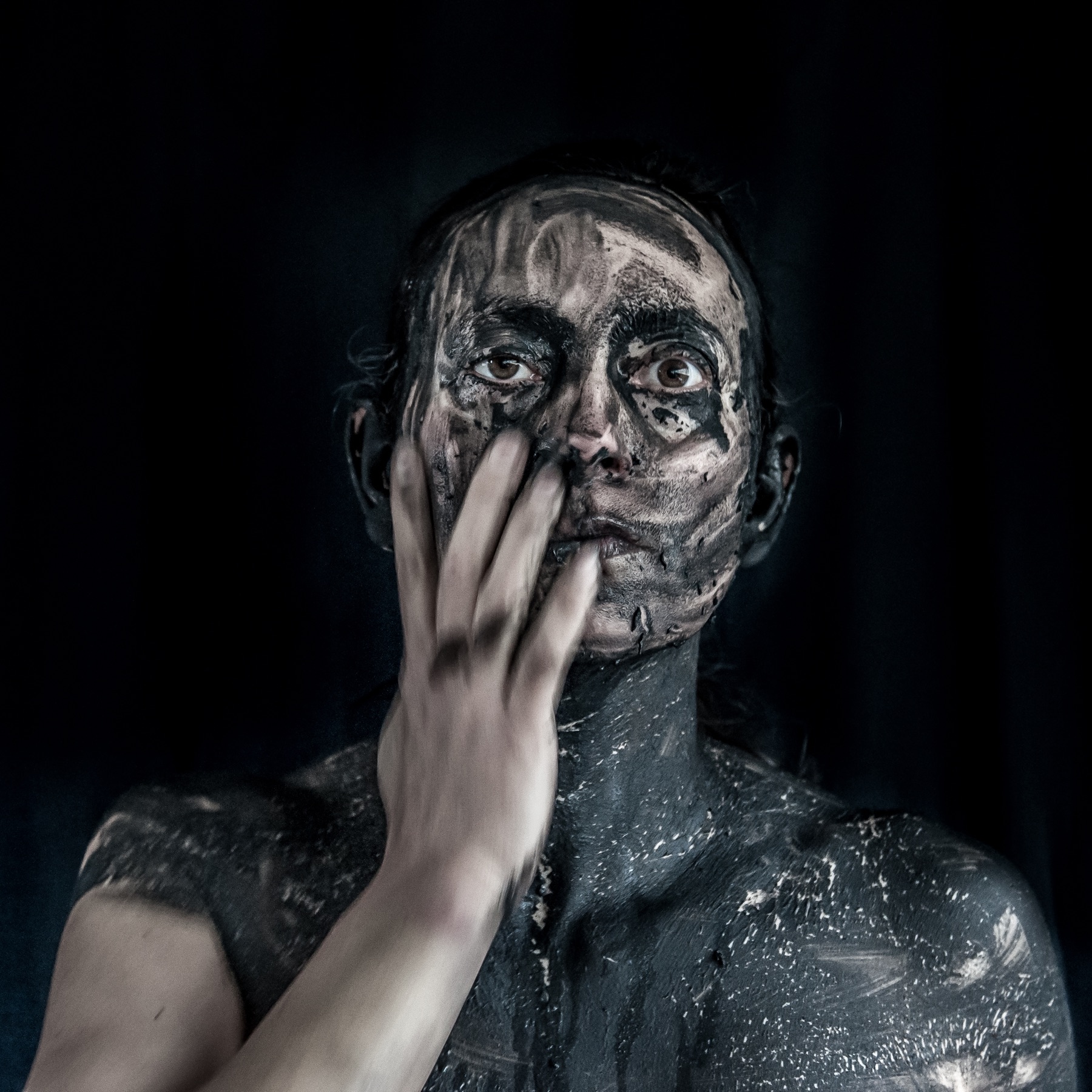Still from Dis-appear: hand touching the face