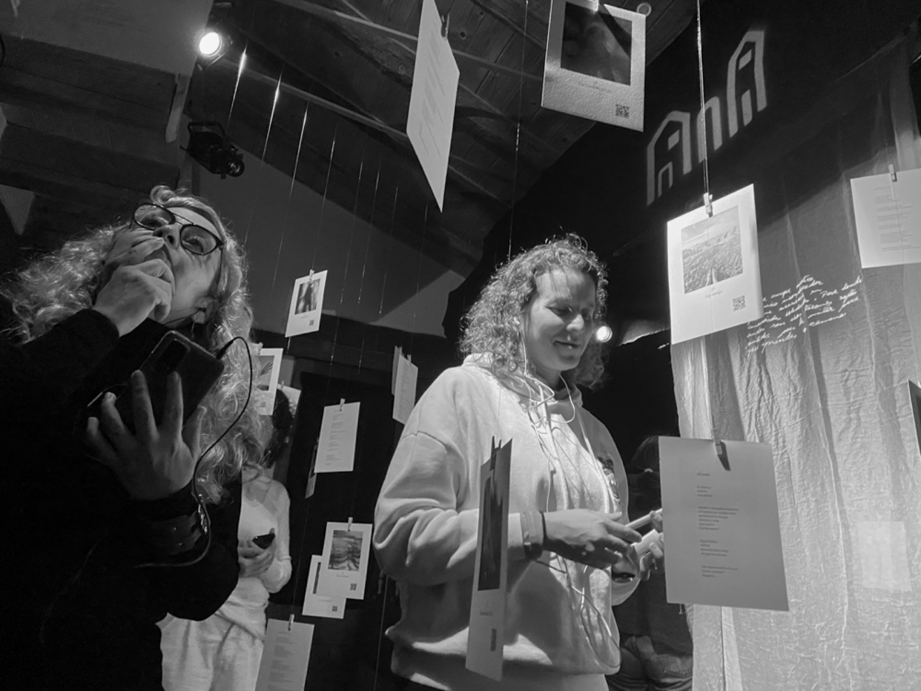 Visitors listening inside the Ella installation