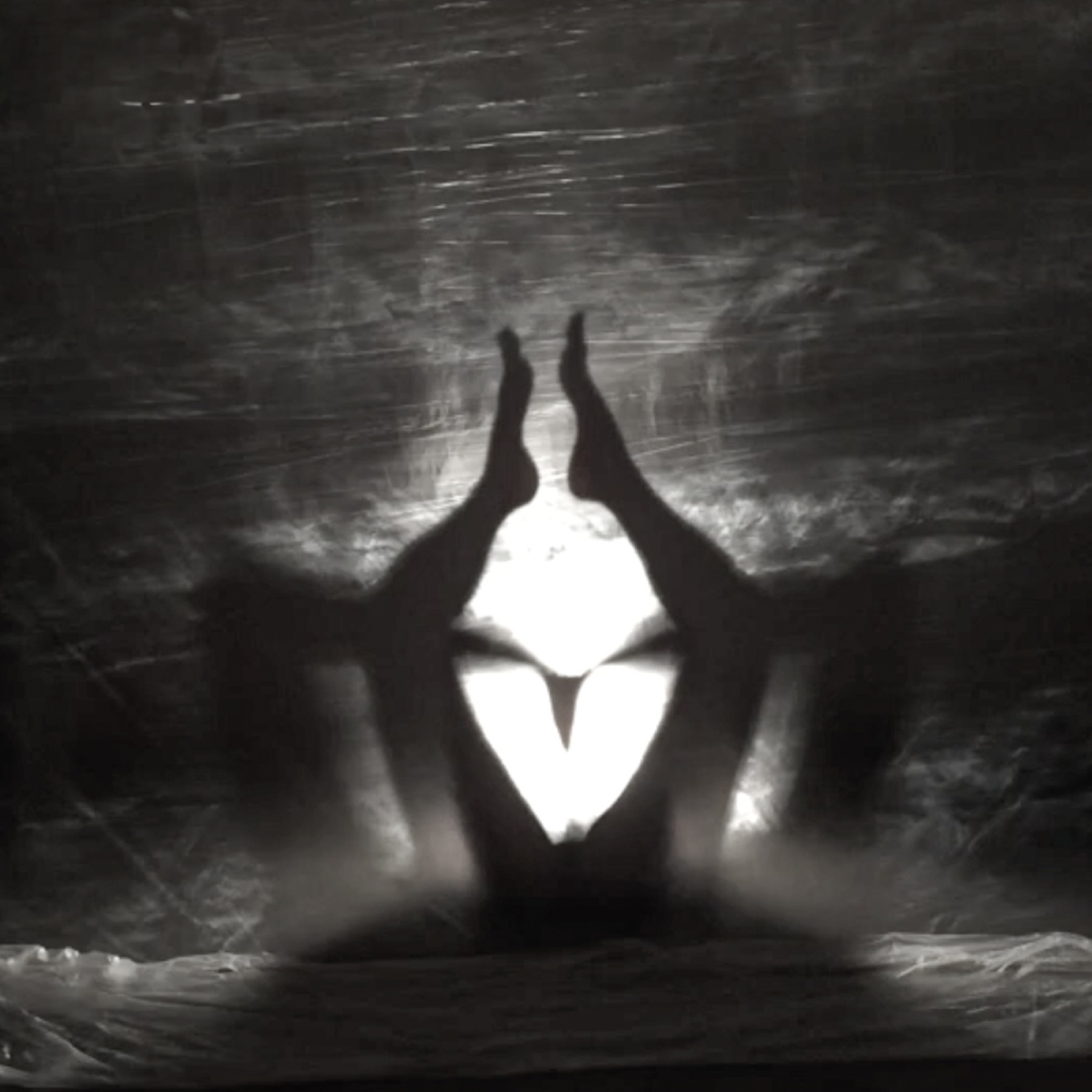 Hands and body forming a luminous threshold