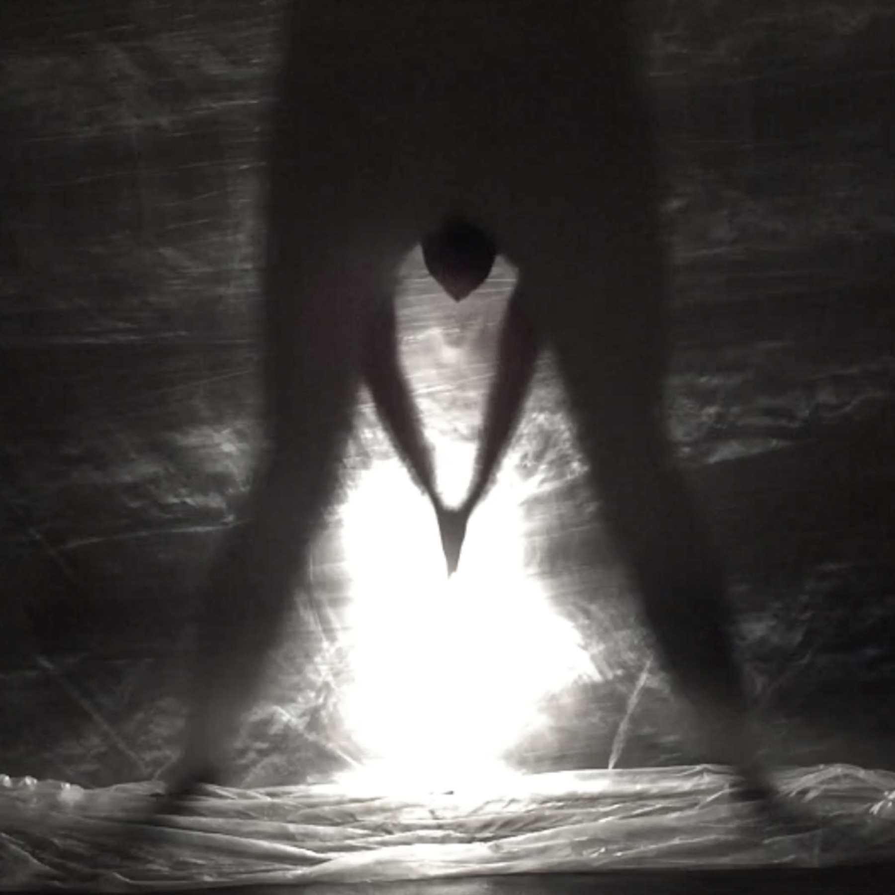 The performer standing within the light
