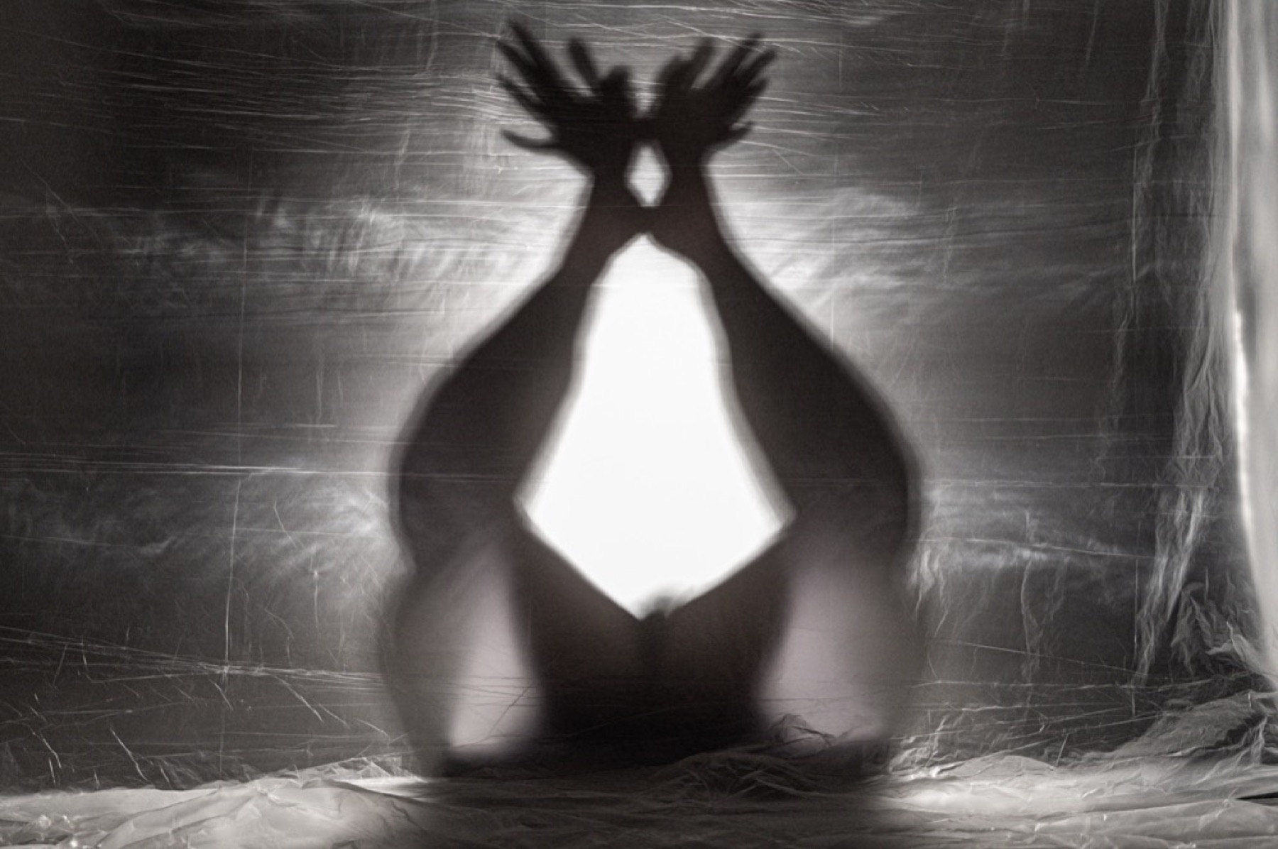 Hands opening above the body in the performance