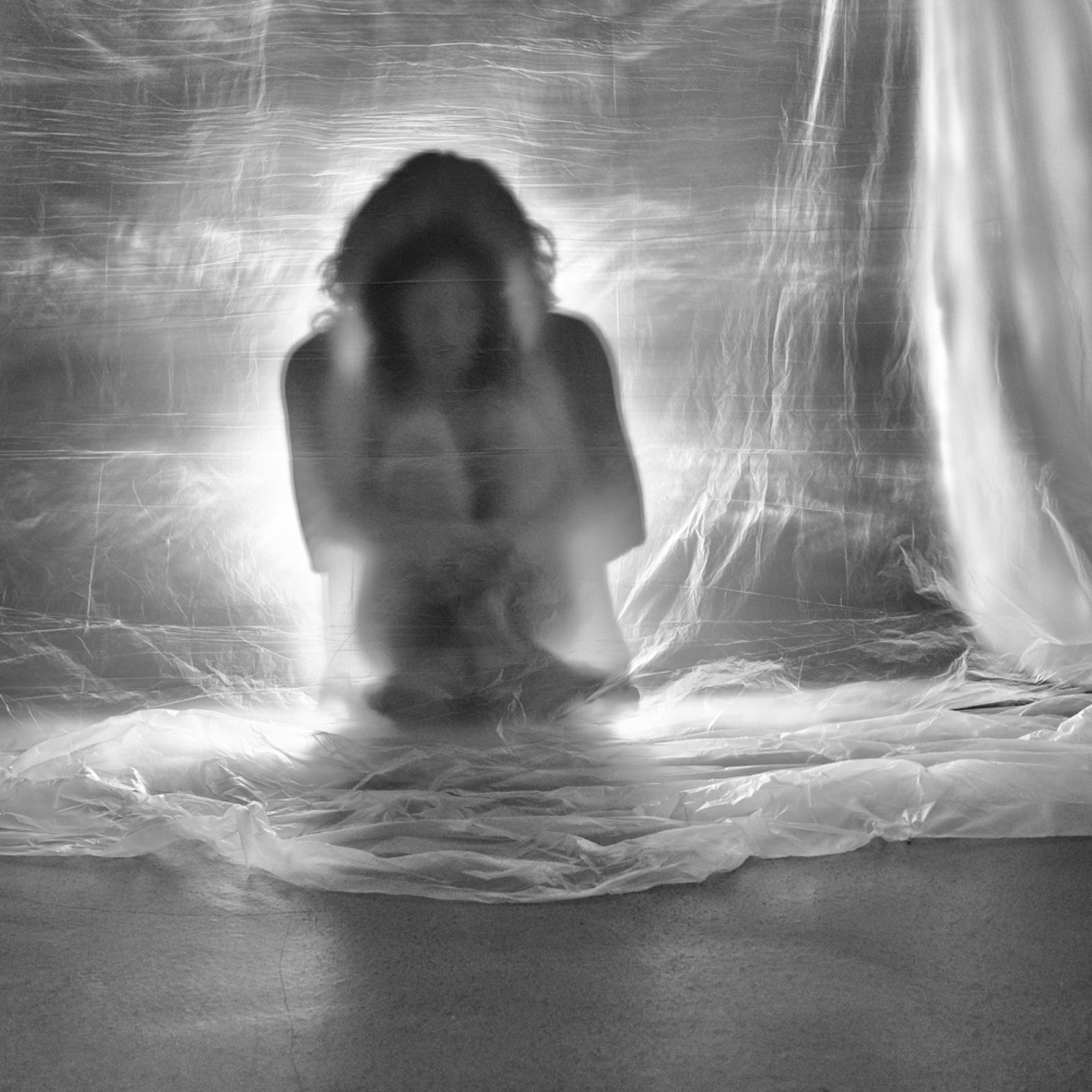 The performer crouched within the installation