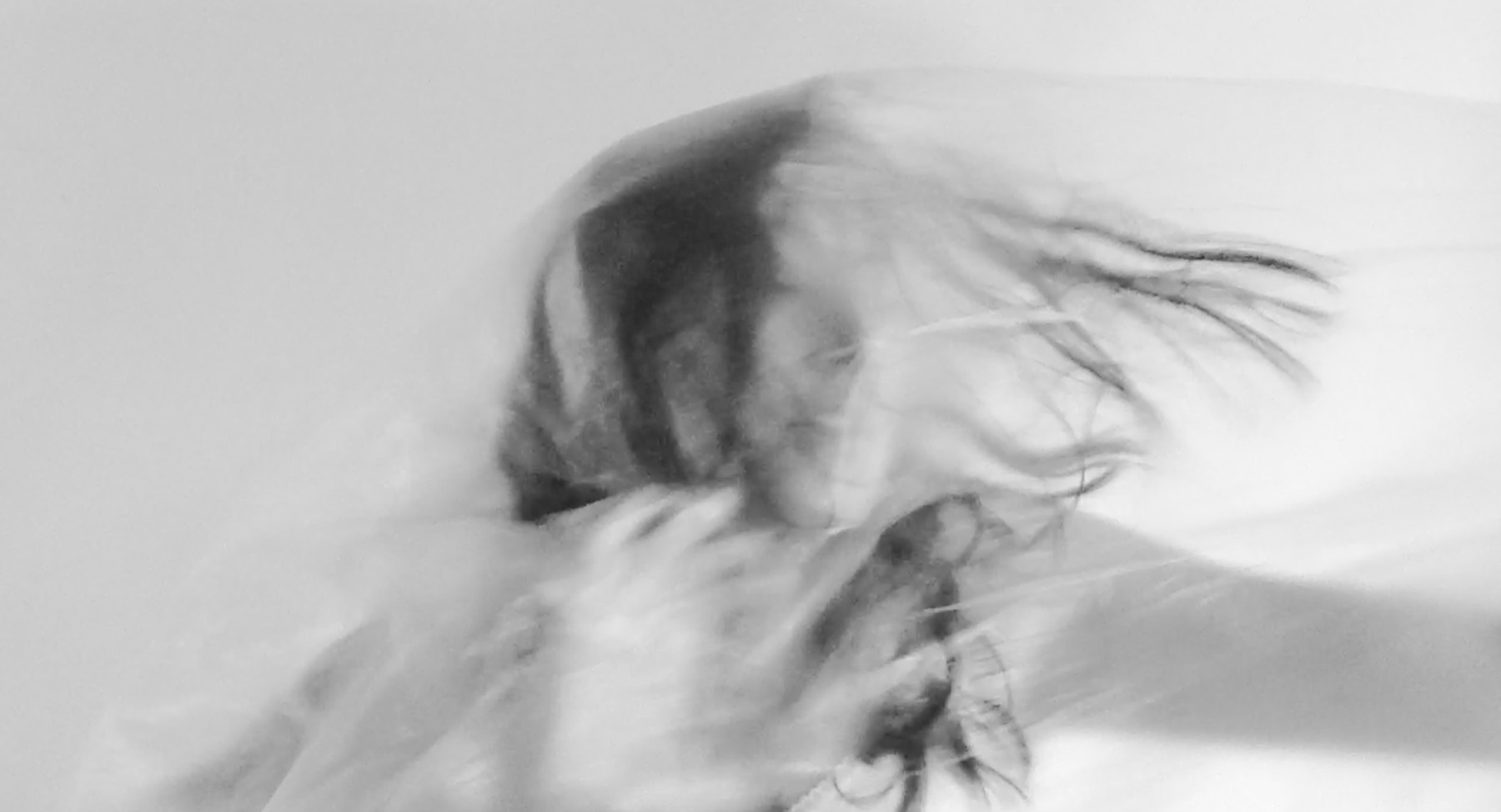 Still from Un-veil: hands lifting the translucent veil